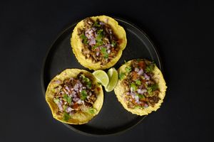 Jackfruit Carnitas Tacos - Shredded tender jackfruit in authentic Mexican marinade on soft corn tortillas, topped with diced red onion, cilantro, and chipotle salsa. at Nabati Bistro in Dubai