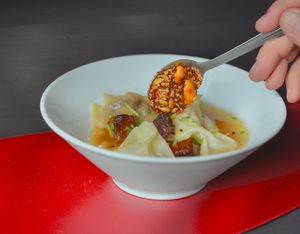 Wonton soup. It's is made with strir-fryed mushrooms and home made vegetable broth. Garnished with marinated fryed tofu and salsa macha in case you eat spicy foods. at El Exceso Food Truck in Mexico City