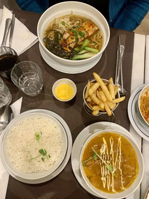 Chicken tikka masala and tofu ramen, and garlic butter chips with cheese sauce   at Veganapati in Lisbon