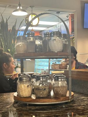 all kinds of stuff to sprinkle at Vegan Pizza in Garden Grove