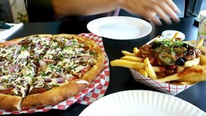 Meat lovers with onions spinach and mushrooms and chili fries at Vegan Pizza in Garden Grove
