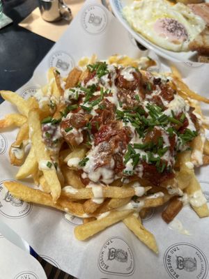 French fries with tomato sauce and onions, eggplant and more  at Blossom Owl in Kalamata