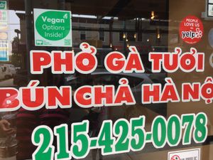 Front door, advertising vegan options at Thang Long Noodle Restaurant in Philadelphia