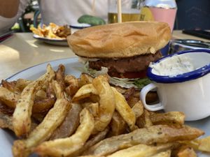 Beyond burger with brioche bun, with vegan tartar sauce (the white sauce). The one we liked most. On Mondays the fries are free.   at Skapto  in Sofia