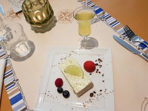 Citroen bavarois met cacaonibs. Erbij een glas limoncello at Veggies on Fire in The Hague