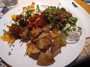 Seitansaté met barbecuesaus, aardappelen met o.a. rozemarijn, salade en mayonaise at Veggies on Fire in The Hague