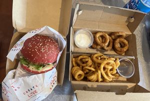 Chicken sandwich, curly fries, onion rings   at Vegan Pirates by CloudEatery in Berlin