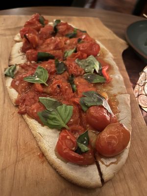 Gluten free version of the cherry tomato flatbread  at Bar Avelo in Toronto