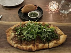 Caramelized onion flatbread and lentil empenada.  at Bar Avelo in Toronto