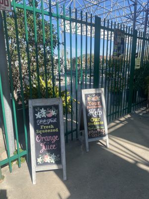 Outdoor Signage and Plants for Sale in Background  at Cal Poly Pomona Farm Store at Kellogg Ranch in Pomona