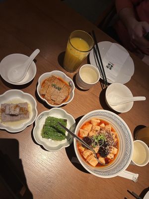 Selection of dishes including a passion fruit drink, mapo tofu and sour vegetables  at Qing Chun By Perma in Shanghai