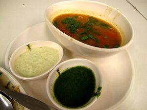 Condiments that you get when you order southern indian dishes like uttapam or dosa. White is coconut chutney, red is rasam and green is mint sauce.  at Cha Cha's South Indian Vegetarian in Bangkok
