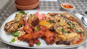 Spicy potatoes + tteokbokki with oyster wings at YUBA  in Poznan