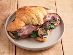 Croissant filled with Mushrooms, baby Spinach, plantbased cream-cheese and no-Bacon at Natury in Barcelona