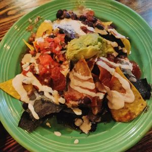 Nachos ~melted Daiya cheese, black beans, ranchero sauce, guacamole & homemade sour cream at The Grain Cafe in Los Angeles
