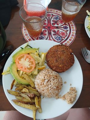 Curried lentil burger with rice and vegetable salad. Sweet coconut on the side at Govindas in Santa Marta