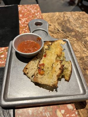 Complimentary focaccia and sauce    at Almacen De Pizzas in Asuncion