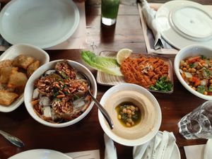Dishes from left to right include fattayer (vegan), fatteh makdous (vegetarian), hummus (vegan), muhammara (vegan) and musabbahat Jdoudna (vegan) at Haret Jdoudna - مطعم حارة جدودنا in Madaba