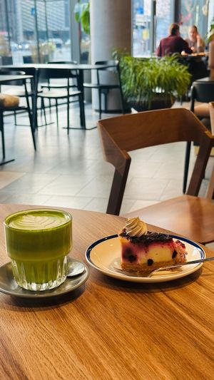 Matcha latte and cheese cake with blueberry  at KIRAS - PC Europa in Vilnius