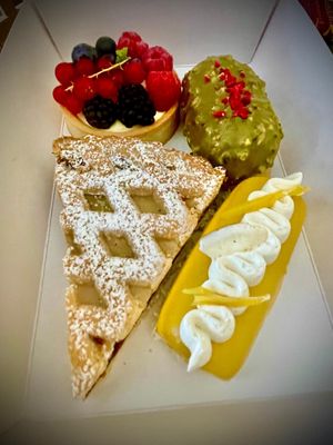 Our choices: cream and berries tart, pistacchio and raspberry semifreddo, coconut and mango semifreddo, ricotta and visciole tart at Julietta Pastry and Lab in Rome
