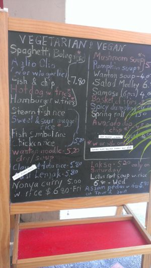 look for menu board outside cafe at Veggie Cottage in Central Singapore