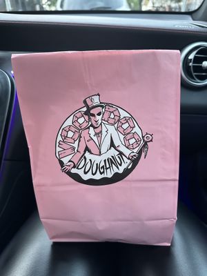 Cute branding and bag  at Voodoo Doughnut in Dallas