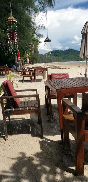 Beach tables and loungers with a view. There are also shaded tables behind this. at JJ Resort & Restaurant in Koh Phayam