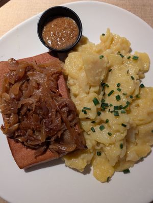 Vegan meatloaf with potato salad and fried onions at Augustiner am Heumarkt in Cologne