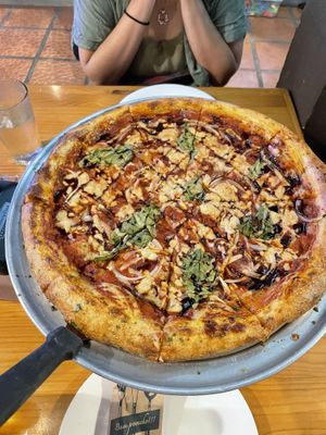 Large vegan pizza with roasted onions, roasted garlic, spinach, and a balsamic glaze  at The Pizza Shop in Jaco