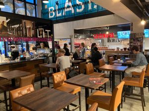 Dining area. To the right is the order counter. To the left is the bar where you pick up your drink. And just to the right of the red Cucinova sign is where you pick up your food.  at VeJin Tokyo Vege Ramen  in Tokyo