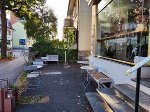 Outdoor seating (in autumn) at Bees & Birds Cafe in Basel