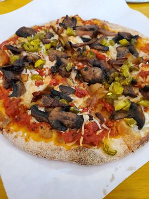 Pizza has mushrooms, onions, jalapeños, sun dried tomatoes at Mexitaly in York