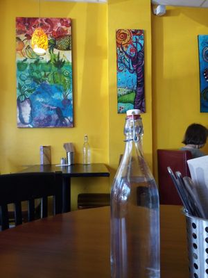Filtered water for the tables, colorful art on the walls at Portia's Cafe in Columbus