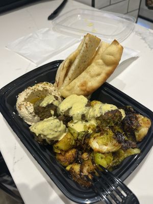 Built our own bowl with hummus, falafel, pita, and Brussel sprouts    at SLC - Vessel Kitchen - Concourse A in Salt Lake City