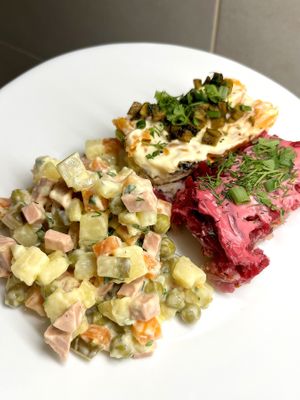 Range of veganized New Year's Russian salads: Olivier, Selyodka pod shuboy (Herring under a fur coat), and Mimosa at BORSHÖF in Yerevan