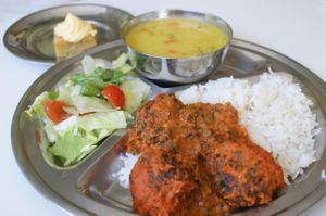 Spinach balls on tomato souse with rice, dhal and salad.
 at Vegetarian Dinner Club in Amsterdam