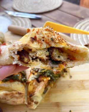 The slice of divine vegan Calzone pizza 💫 You can see the fried and juicy pieces of lentil tofu inside, it's sooooo delicious, just mind-blowing! at Dilijan Fresh in Dilijan