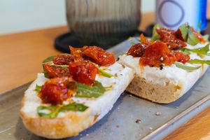 Crispy French baguette with our Mo'rella vegan mozzarella, peppery rocket & oven-baked caramelized cherry tomatoes - Mediterranean bliss in every bite! 🌅🍅 at Veganaria in Ponta Do Sol