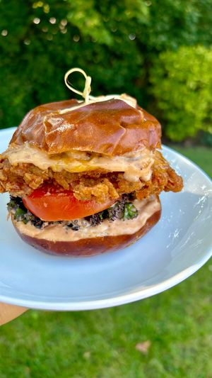 Pretzel Bun, Fried Chik'n (Oyster Mushroom) Sandwich, House-made Spicy Mayo Sauce, Lettuce, Tomato at Sedjedo Kitchen in Bellmore