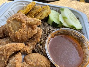 Diri djon djon black rice with breaded and fried oyster mushrooms and tostones  at Sedjedo Kitchen in Bellmore