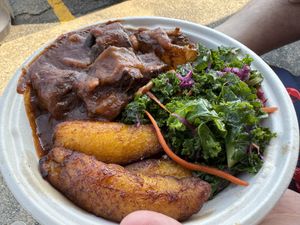Oxtails bowl with sweet plantains and kale slaw. (Rice and kidney beans under everything)  at Sedjedo Kitchen in Bellmore