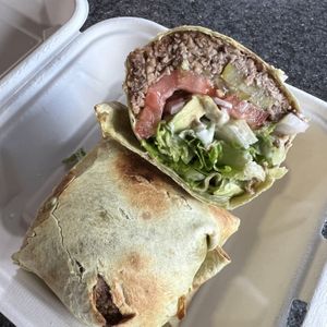 AVOCADO ZONE WRAP: Spinach wrap, lentil walnut burger, vegan cheese option, romaine, pickles, red onions, tomatoes, avocado, Vegenaise.  at Erie Food Co-op in Erie