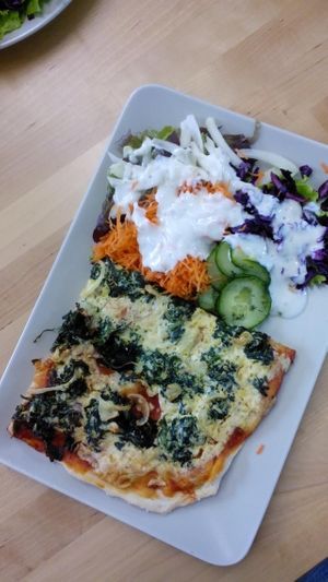 Pizza with salad  at Immergruen Bistro and Cafe in Harsewinkel