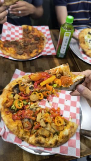 Loaded veggie or whatever it's called plus chick'n, so good! The meat(less) lover's in the background 🤤 at Wild Pie  in Jacksonville
