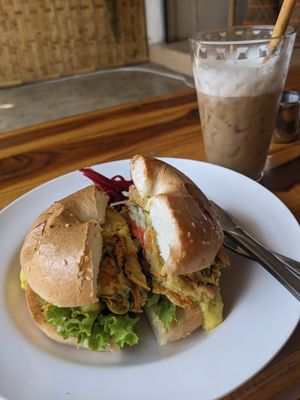 Breakfast Bagel with "omelette", veg and "cheese" and an iced oat cappuccino at Free Bird Cafe Pai in Pai