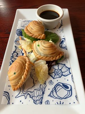 Thai Chives Puff appetizer. Seasoned chopped chives vegetables wrapped in puff pastry and deep fried. Served with Thai-chili soy dipping sauce. at Joy's Pattaya Thai Restaurant in Richfield