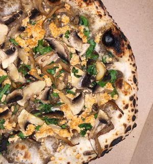 Pizza with mushrooms, greens and marinated onion at Daner Pizza in Tbilisi