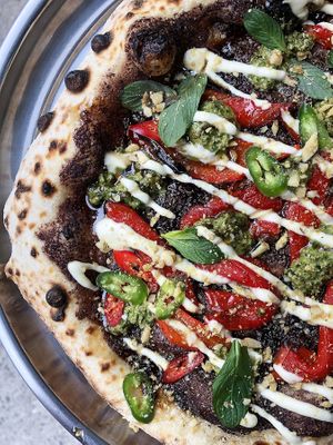 The yummiest special in January 2024: tapenada base, baked peppers, cilantro pesto, mint, cashew sauce, narsharab and walnut topping at Daner Pizza in Tbilisi