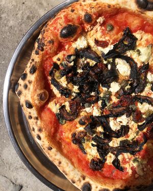 B-Day special pizza with tomato base, red basil, cashew sauce, wakame-unagi-eggplant topping, tofu, capers, sun dried tomatoes at Daner Pizza in Tbilisi