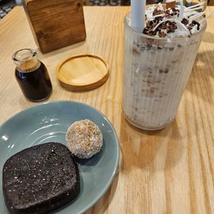 Coconut coffee blended with ice, plus no bake brownie and carrot cake ball at iVegan Supershop Old Quarter Hanoi - Healthy Plant Based Cafe in Hanoi